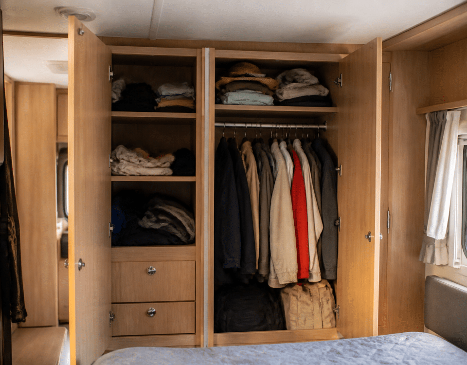 Armoires integrees avec portes ouvertes rangant vetements et accessoires camping-car